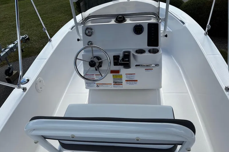 Slide: The Image of 2026 Robalo R160 Center Console boat interior with steering wheel and control panel. - 12