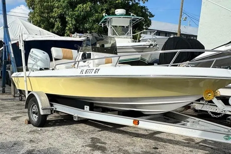 The Image of 1997 Seaswirl 1730 CC Striper boat on trailer, parked outdoors. - 0