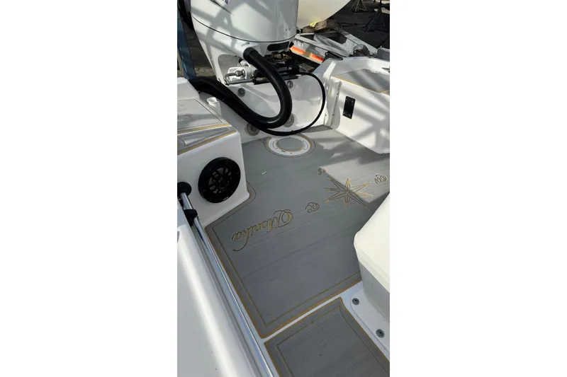Slide: The Image of 1997 Seaswirl 1730 CC Striper boat interior with compass design on deck. - 11