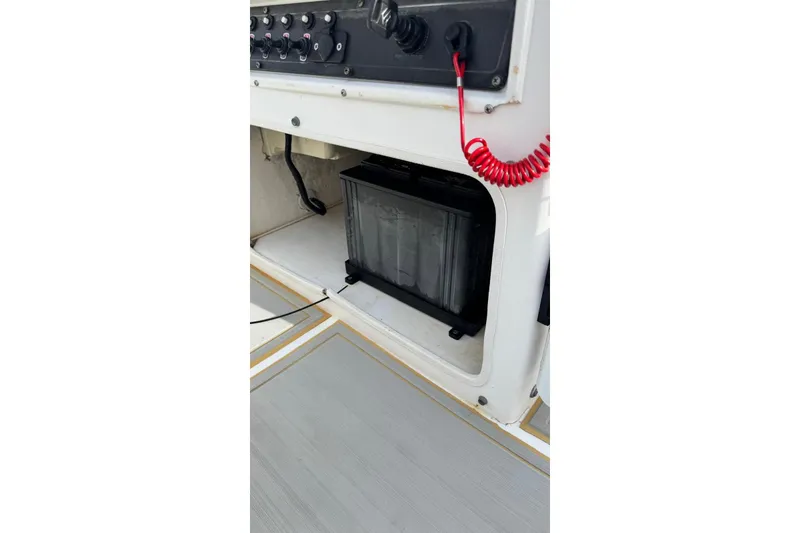 Slide: The Image of 1997 Seaswirl 1730 CC Striper boat console with battery compartment and control panel. - 12