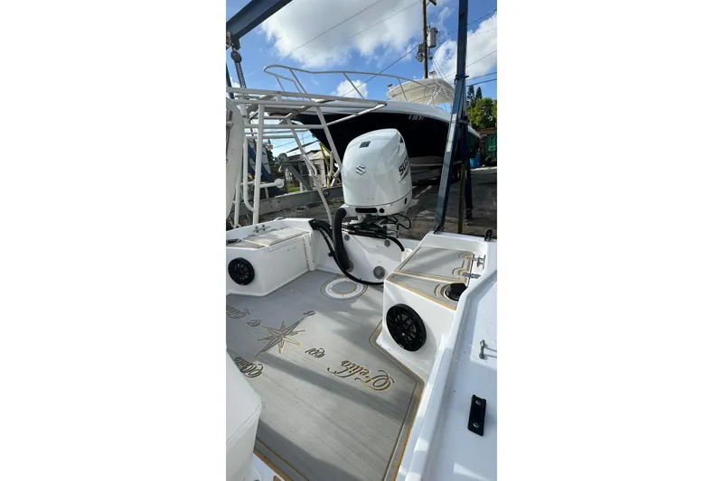 Slide: The Image of 1997 Seaswirl 1730 CC Striper boat with Suzuki outboard motor, docked under blue sky. - 14