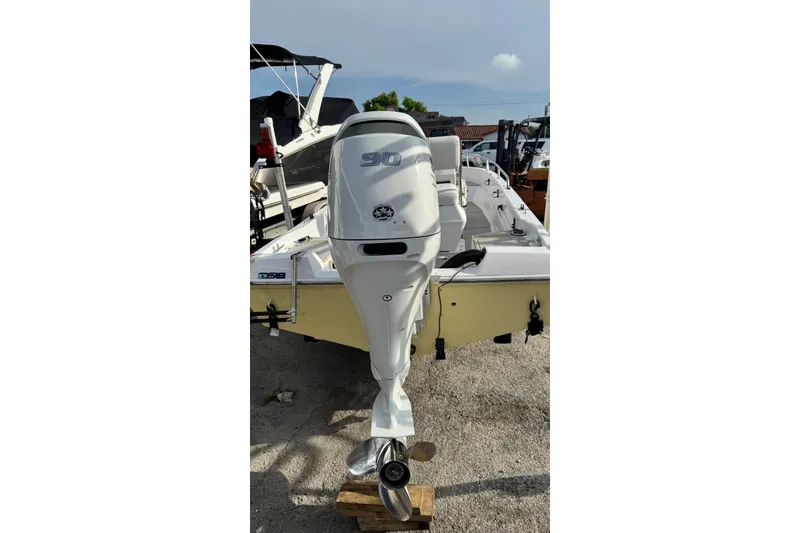 Slide: The Image of 1997 Seaswirl 1730 CC Striper boat with 90 HP outboard motor, parked on gravel. - 6