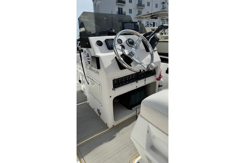 Slide: The Image of 1997 Seaswirl 1730 CC Striper boat console with steering wheel and controls. - 8