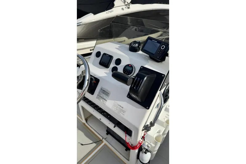 Slide: The Image of 1997 Seaswirl 1730 CC Striper boat console with steering wheel and navigation equipment. - 9