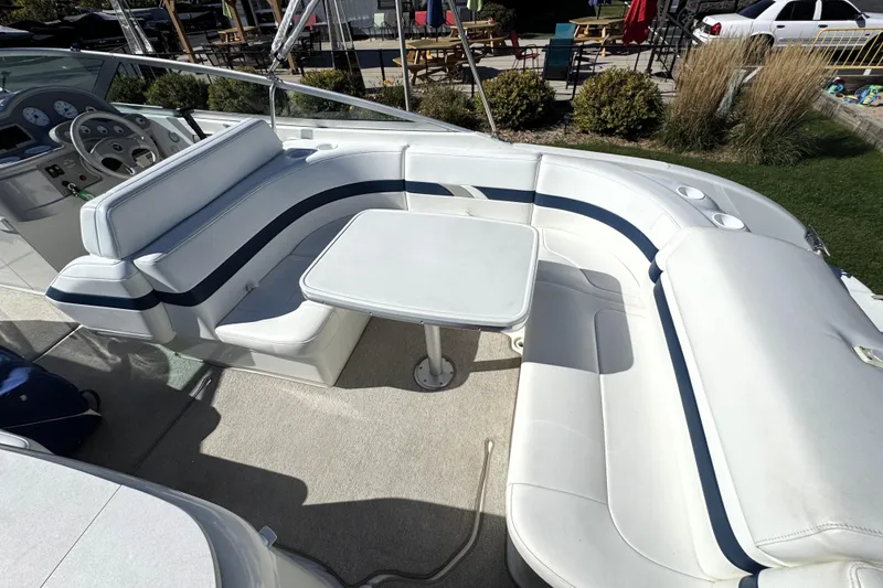 Slide: The Image of 2000 Formula 260 Bowrider boat interior with white seating and table. - 15