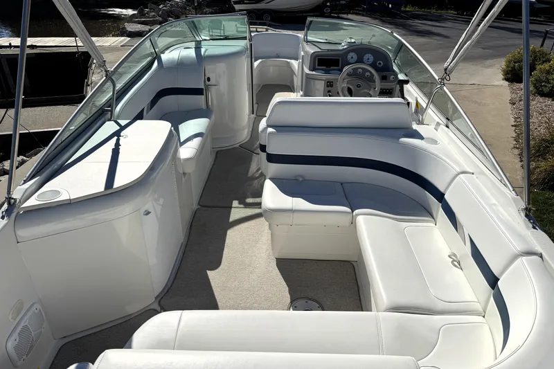 Slide: The Image of 2000 Formula 260 Bowrider interior with white seating and steering console. - 17