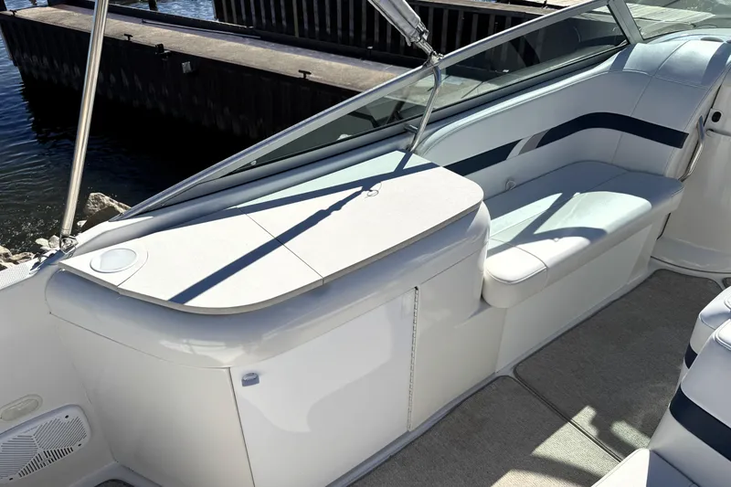 Slide: The Image of Interior of a 2000 Formula 260 Bowrider boat with white seating and sleek design. - 20