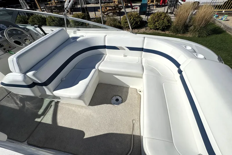 Slide: The Image of 2000 Formula 260 Bowrider boat interior with white seating and steering wheel. - 21