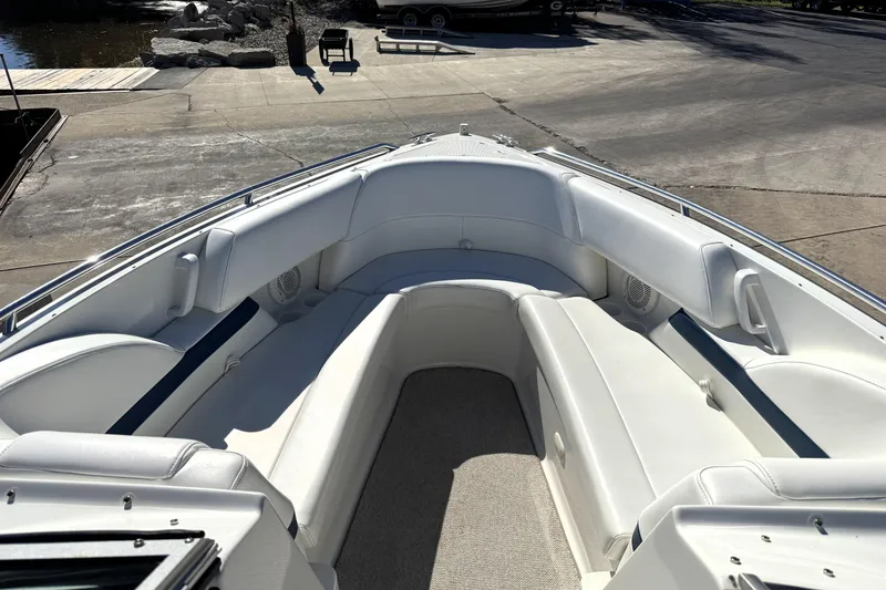 Slide: The Image of 2000 Formula 260 Bowrider boat with spacious white seating and carpeted floor. - 22