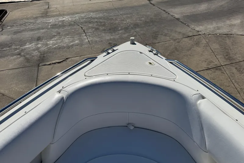 Slide: The Image of Bow seating area of a 2000 Formula 260 Bowrider boat, showing white upholstery. - 23