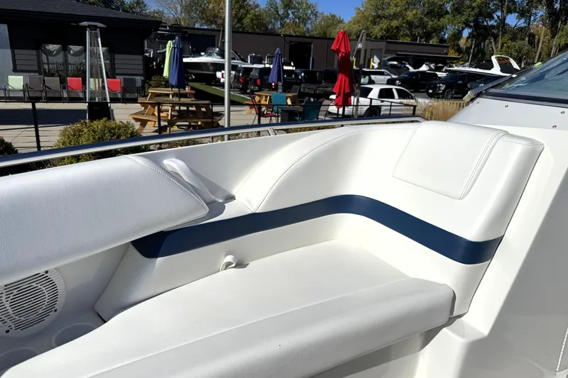 Slide: The Image of 2000 Formula 260 Bowrider boat interior with white and blue seating, outdoor setting. - 25