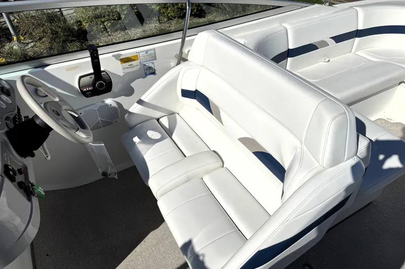 Slide: The Image of Interior of 2000 Formula 260 Bowrider boat with white seating and steering wheel. - 31