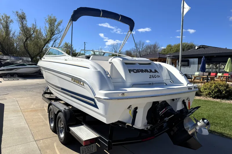 Slide: The Image of 2000 Formula 260 Bowrider boat on trailer, sunny day, outdoor setting. - 5
