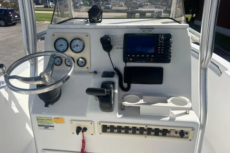 Slide: The Image of Control panel of a 2007 NauticStar 2000 Offshore boat with steering wheel and gauges. - 12