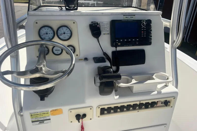 Slide: The Image of 2007 NauticStar 2000 Offshore boat dashboard with steering wheel, gauges, and navigation equipment. - 13
