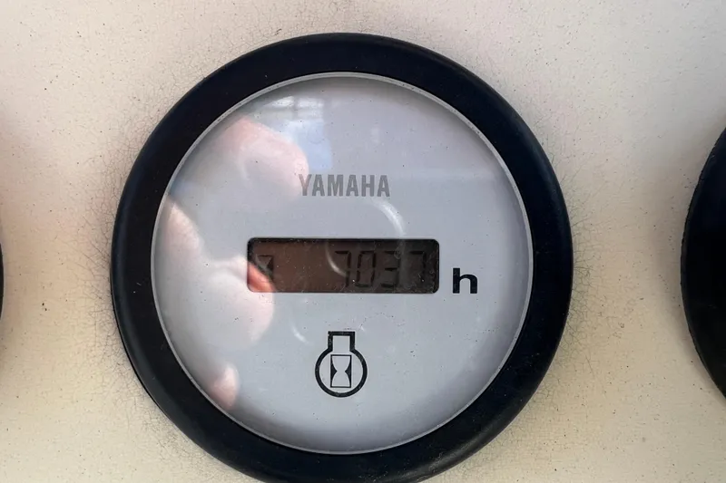 Slide: The Image of Yamaha hour meter displaying 703.7 hours on a 2007 NauticStar 2000 Offshore boat. - 16