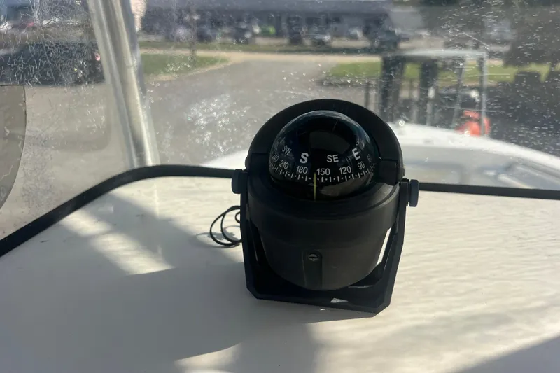 Slide: The Image of Compass on 2007 NauticStar 2000 Offshore boat dashboard, showing southeast direction. - 20