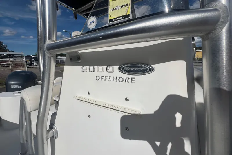 Slide: The Image of 2007 NauticStar 2000 Offshore boat with Sport emblem, docked under clear skies. - 28