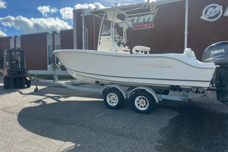 Slide: The Image of 2007 NauticStar 2000 Offshore boat on trailer, parked outside a building. - 3
