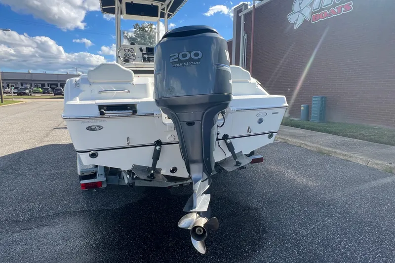 Slide: The Image of 2007 NauticStar 2000 Offshore boat with 200 horsepower outboard motor, parked outdoors. - 40