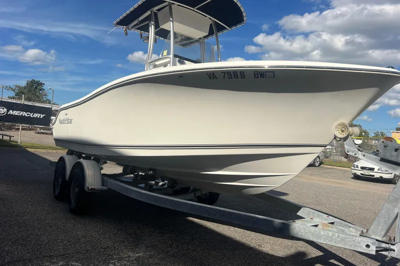 Slide: The Image of 2007 NauticStar 2000 Offshore boat on trailer under blue sky. - 9