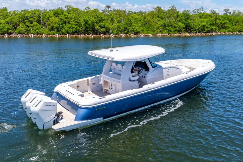 Slide: The Image of 2025 Intrepid 41 Panacea boat cruising on a serene waterway. - 1