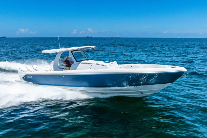 Slide: The Image of 2025 Intrepid 41 Panacea cruising on open blue ocean under clear sky. - 10