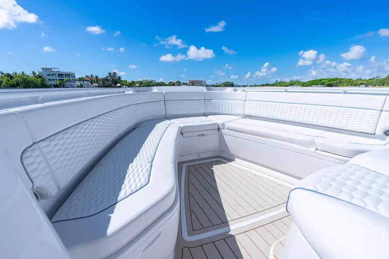 Slide: The Image of Luxurious seating on the 2025 Intrepid 41 Panacea boat under a clear blue sky. - 13