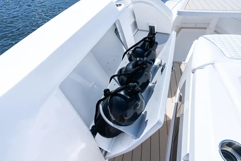 Slide: The Image of Storage compartment on 2025 Intrepid 41 Panacea boat with black fenders. - 14