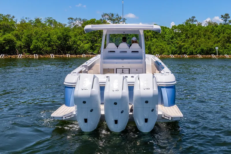 Slide: The Image of 2025 Intrepid 41 Panacea boat with triple outboard engines on water. - 2