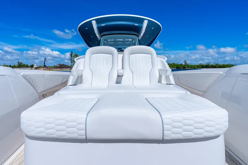 Slide: The Image of Luxurious 2025 Intrepid 41 Panacea boat with sleek white seating under a clear blue sky. - 24