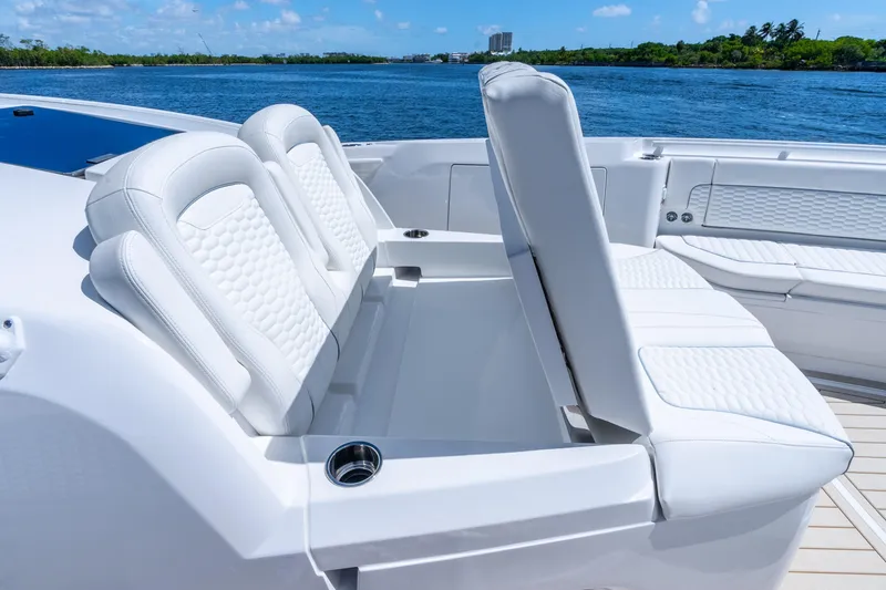Slide: The Image of Luxurious seating on 2025 Intrepid 41 Panacea yacht, featuring white upholstery and ocean backdrop. - 25