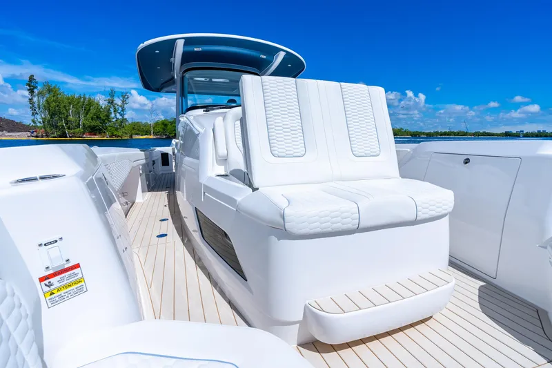 Slide: The Image of Luxurious 2025 Intrepid 41 Panacea boat interior with white seating and sleek design. - 27