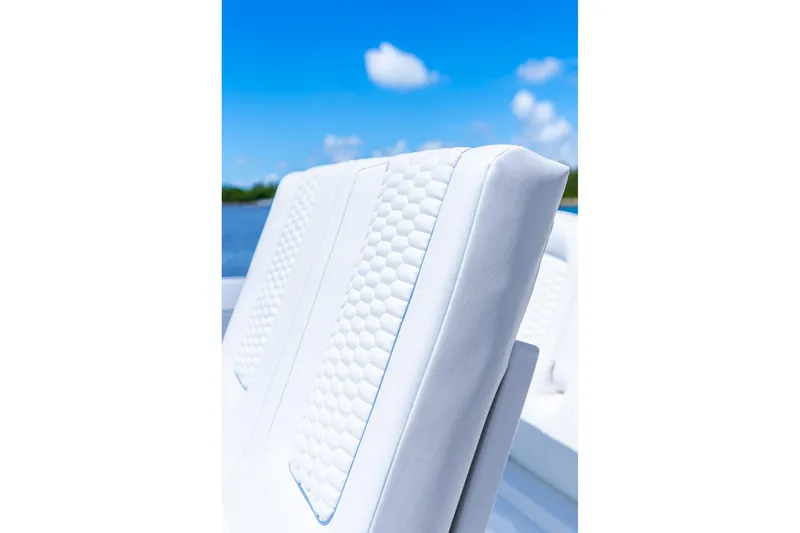 Slide: The Image of White cushioned seat on 2025 Intrepid 41 Panacea boat under clear blue sky. - 28