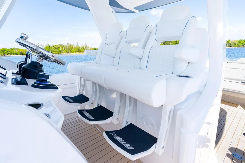 Slide: The Image of Luxury seating on 2025 Intrepid 41 Panacea boat, featuring sleek white design and modern controls. - 30