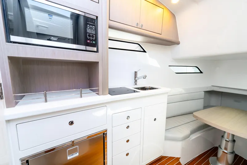 Slide: The Image of Modern kitchen interior of 2025 Intrepid 41 Panacea yacht with sleek cabinetry and seating. - 37