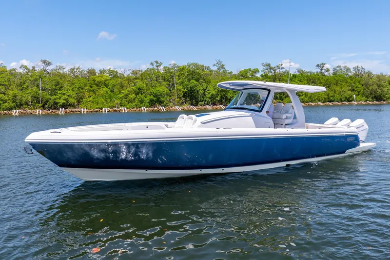 Slide: The Image of 2025 Intrepid 41 Panacea boat on water, sleek design, blue and white exterior. - 4