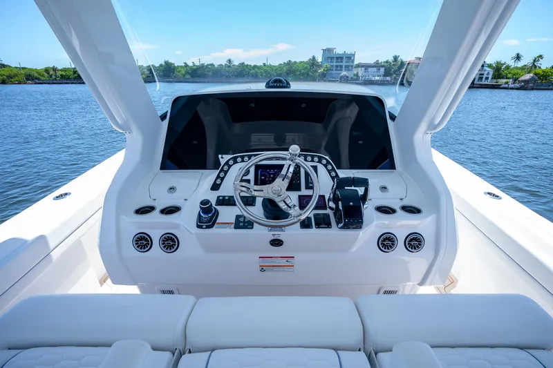 Slide: The Image of Helm of 2025 Intrepid 41 Panacea yacht with modern controls and scenic water view. - 41