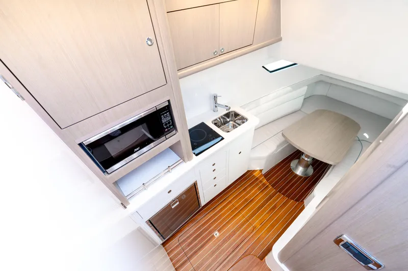 Slide: The Image of Luxurious interior of 2025 Intrepid 41 Panacea yacht with kitchenette and seating area. - 43