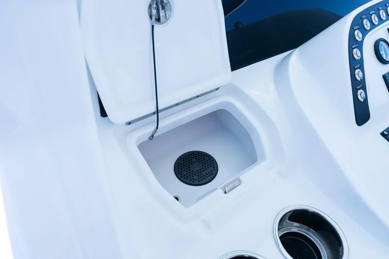 Slide: The Image of 2025 Intrepid 41 Panacea boat console with open compartment and control panel. - 49