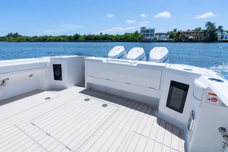 Slide: The Image of 2025 Intrepid 41 Panacea boat deck with triple Mercury engines, on a sunny day. - 52