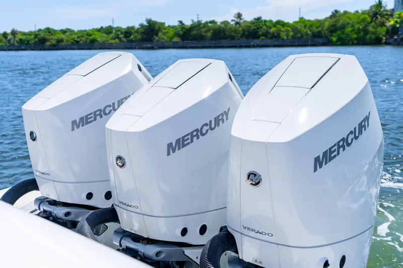 Slide: The Image of Triple Mercury Verado engines on a 2025 Intrepid 41 Panacea boat, cruising on a sunny day. - 56