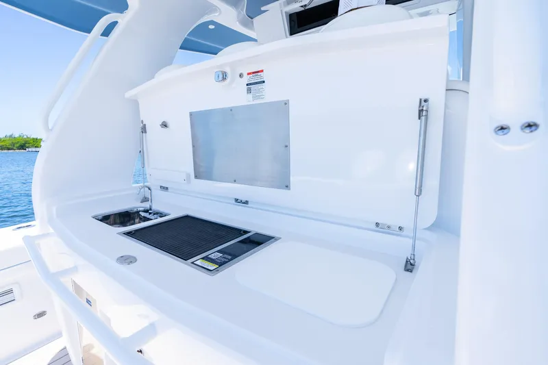 Slide: The Image of 2025 Intrepid 41 Panacea boat kitchen area with sink and grill, ocean view. - 63