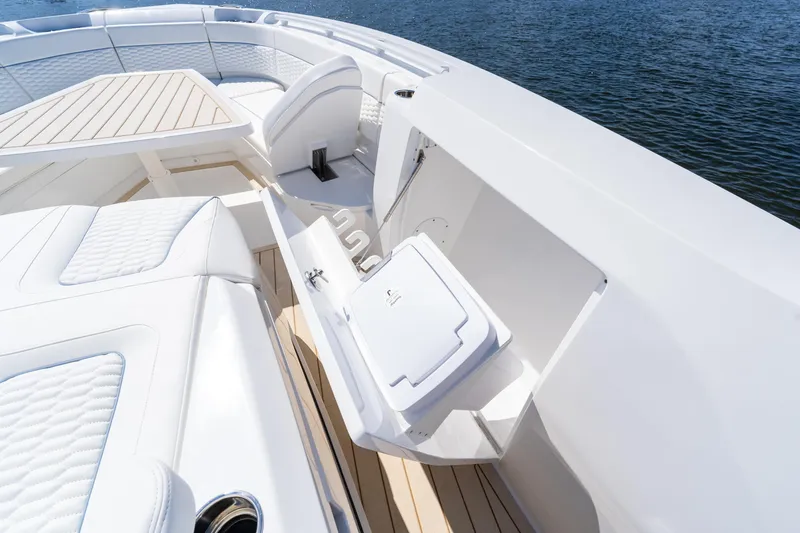 Slide: The Image of Luxurious seating area on 2025 Intrepid 41 Panacea boat, featuring white upholstery and wooden accents. - 65