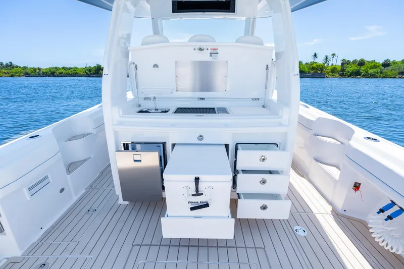 Slide: The Image of 2025 Intrepid 41 Panacea boat interior with open storage drawers and scenic water view. - 66