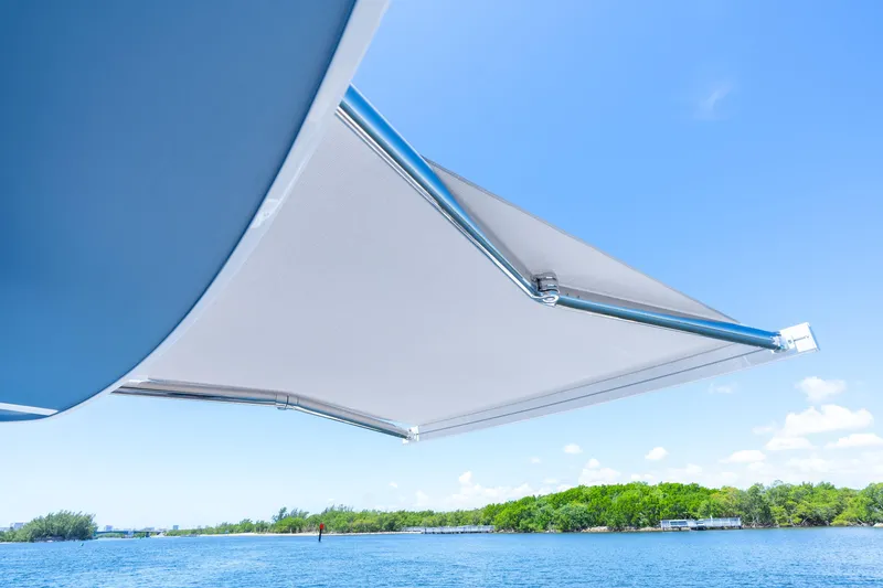 Slide: The Image of 2025 Intrepid 41 Panacea boat awning with scenic water and sky background. - 69