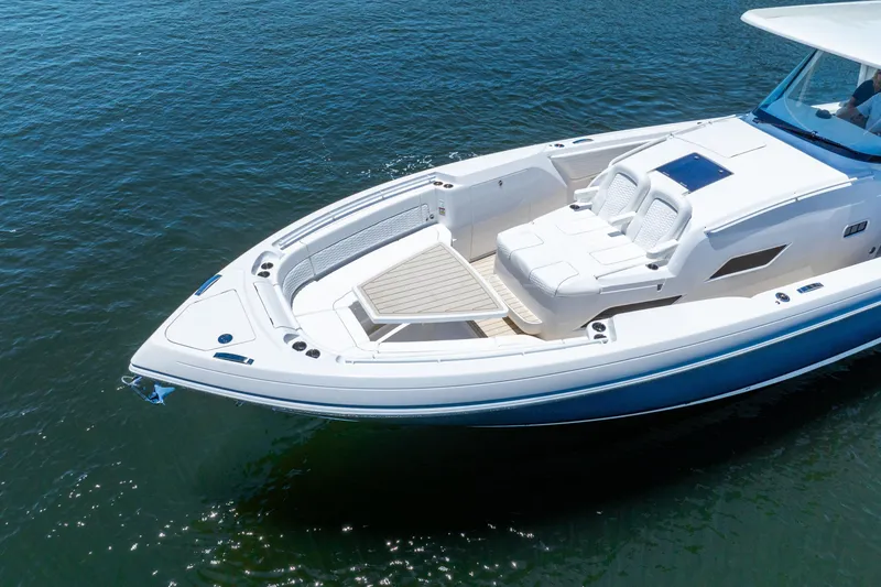 Slide: The Image of 2025 Intrepid 41 Panacea luxury boat on calm water, featuring sleek design and spacious deck. - 7