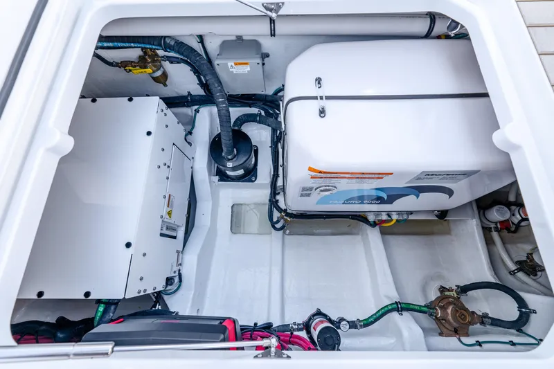 Slide: The Image of Engine compartment of 2025 Intrepid 41 Panacea boat, showcasing mechanical components and wiring. - 71