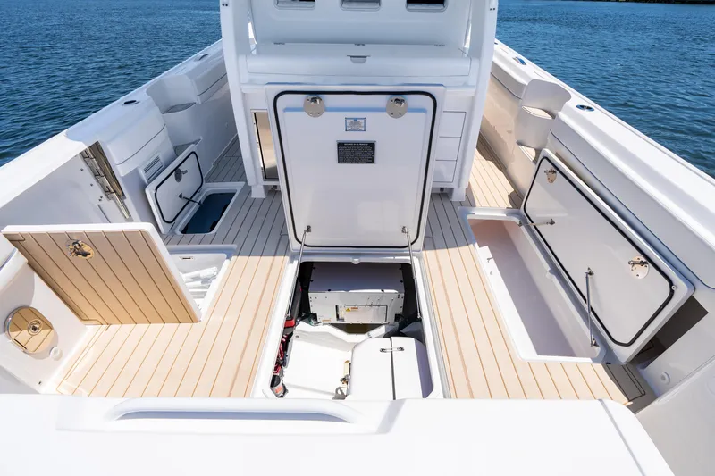 Slide: The Image of 2025 Intrepid 41 Panacea boat interior with open storage compartments and teak flooring. - 76
