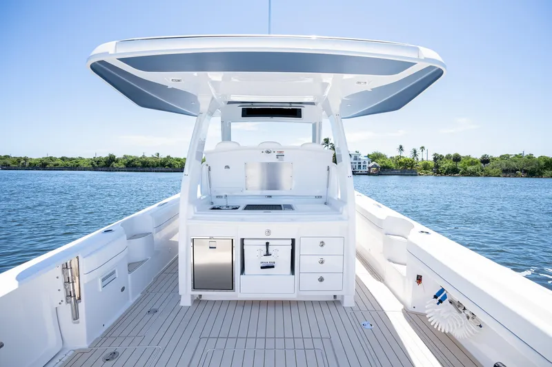 Slide: The Image of 2025 Intrepid 41 Panacea boat interior with sleek design and modern amenities on a sunny day. - 79